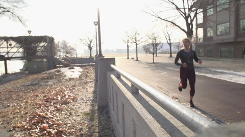 Runner stops and stretches (slider) Stock Footage 33689719