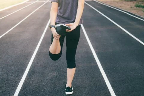Runner stretching legs before run. Stock Photos