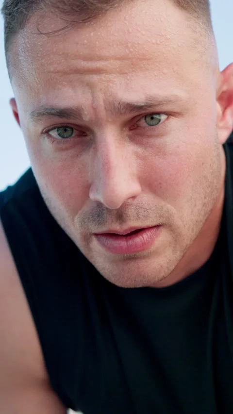 Runner, sweat and face of man for rest in city for exercise, cardio workout and Stock Footage 331053019