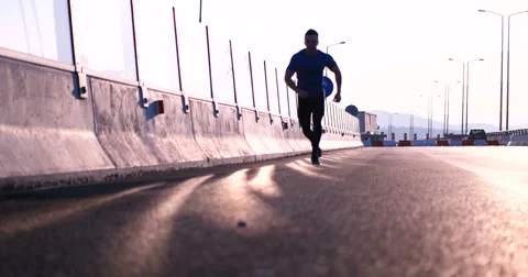 Runner takes a break on highway road Stock Footage 67230565