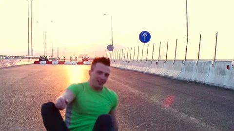 Runner takes a breakon highway road. resting after run Stock Footage 67332075