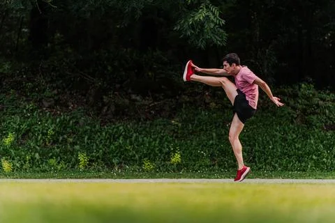 Runner touching toes while warming up on the running track. Copy space Foto stock