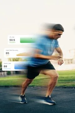 Runner tracking heart rate and performance during training in a sports facility Stock Photos