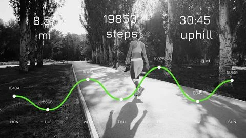 Runner tracks progress during 8.5 mile workout in park with data displayed on Stock Photos