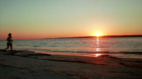 Runner train and enjoys nature by beach sunset  Stock Footage 62925503