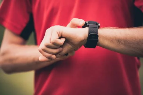 Runner training and using heart rate monitor smart watch Stock Photos