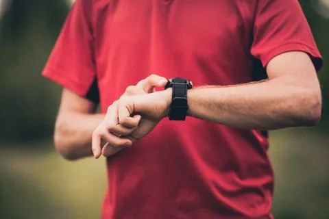 Runner training and using stopwatch with heart rate monitor Stock Photos