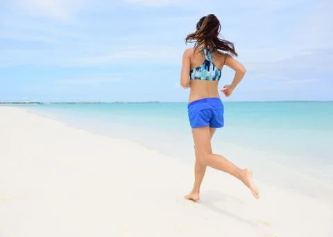 Runner training cardio running on beach Stock Photos
