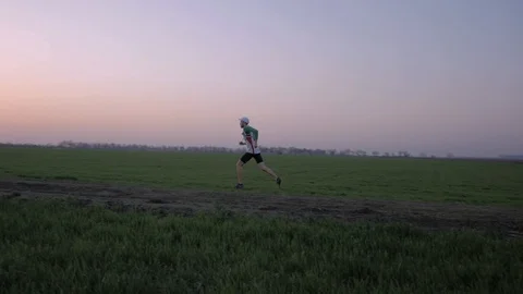 Runner training in fields Stock Footage 91177638