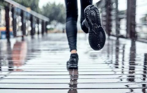 Runner training in the rain, person doing workout and outdoor cardio for Stock Photos