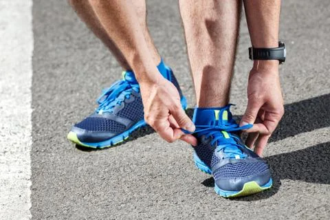 Runner trying running shoes getting ready for run. Stock Photos