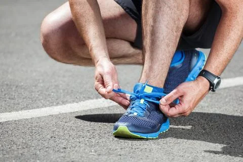Runner trying running shoes getting ready for run. Stock Photos