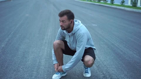 Runner Tying Shoelaces Before Jogging Workout. Stock Footage 141077821