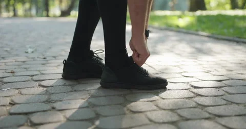 Runner Tying Shoelaces Before Jogging Workout. Triathlon Runner Prepare Footwear Stock Footage 194460370