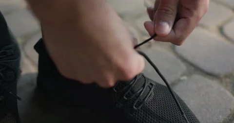 Runner Tying Shoelaces Before Jogging Workout. Triathlon Runner Prepare Footwear Stock Footage 194460409