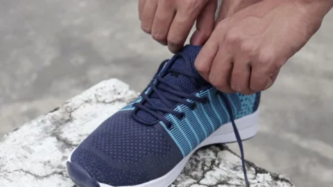 Runner Tying Shoelaces Before Jogging Workout.Triathlon Runner Stock Footage 137882753