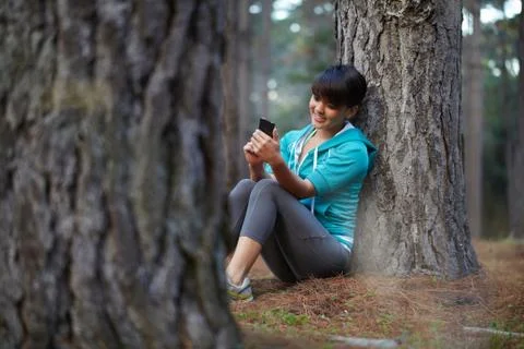 Runner using cell phone in forest 스톡 사진