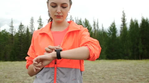 Runner using smartwatch fitness tracker and heart rate monitor watch jogging on Stock Footage 65486899
