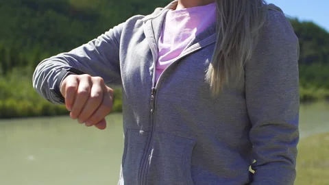 Runner using smartwatch fitness tracker and heart rate monitor watch jogging on Stock Footage 95484256