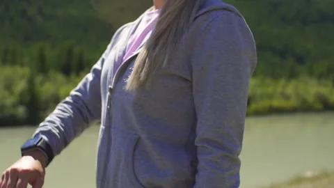 Runner using smartwatch fitness tracker and heart rate monitor watch jogging on Stock Footage 95484444