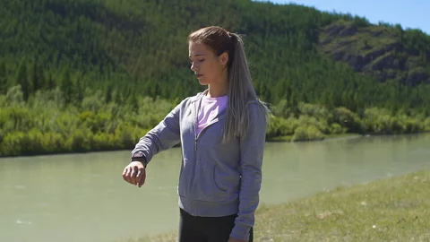 Runner using smartwatch fitness tracker and heart rate monitor watch jogging on Stock Footage 95484653