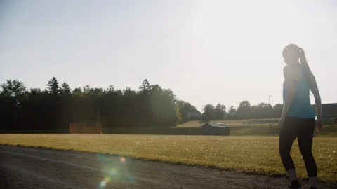 Runner warming up by doing lunges on track at sunrise, slow motion, 4k Stock Footage 111157054