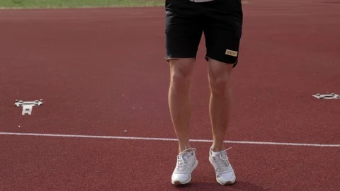 Runner warming up on race track Stock Footage 130138501