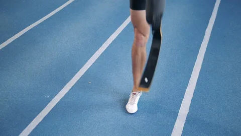 A runner warms up on a track, wearing leg prosthesis. Stock Footage 105004899