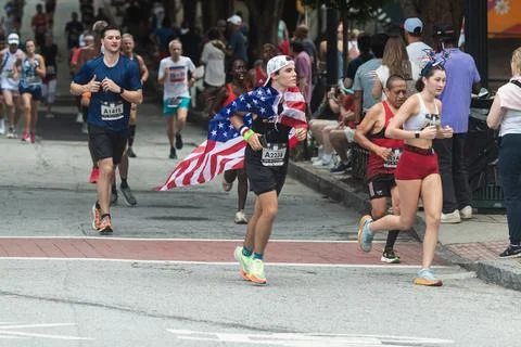 Runner wears American flag as cape in Peachtree Road Race Stock Photos