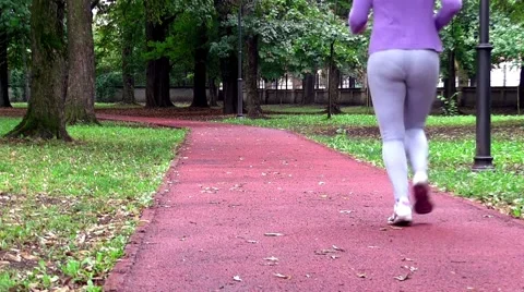 Runner - woman running down path away from camera Stock Footage 41465335