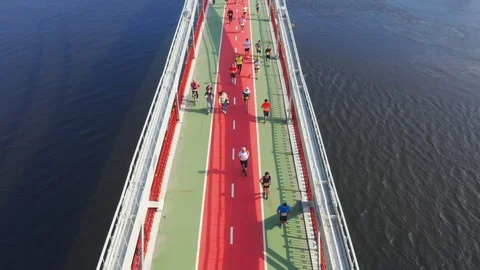 Runners on the bridge during the marathon Stock Footage 106561546