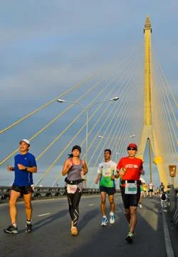 Runners on cable bridge Stock Photos