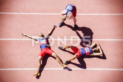 Runners collapsing on track Stock Photos