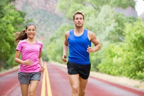 Runners couple in jogging exercise outside Stock Photos