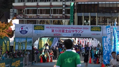 Runners cross the finish line at the Mt. Fuji International Marathon 2024. Stock Footage 346011283