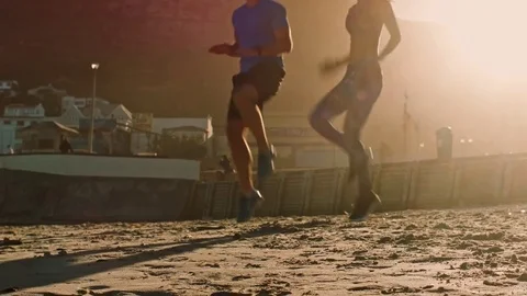 Runners doing speedwork exercise on beach Stock Footage 76521171