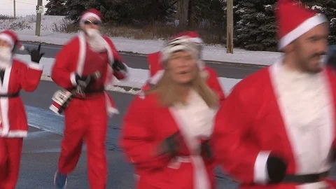 Runners dressed as santa claus in marathon style run through the city Stock Footage 70498340