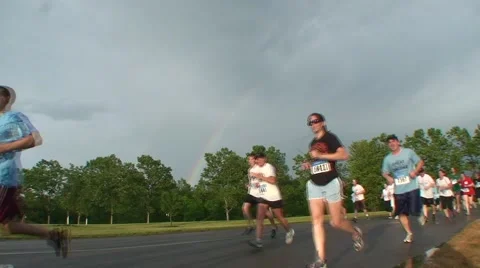 Runners in foreground, rainbow in background Video stock 51180520