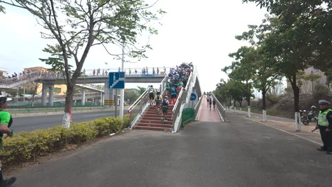 Runners going up the stairs of overhead bridge in China Stock Footage 303870974