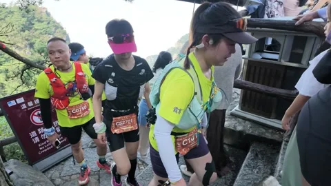 Runners Passing Crowded Walkway Warning Sign on Mountain Trail, Lushan Video stock 346718079