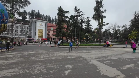 Runners passing through Sapa square in the evening Stock Footage 295031748