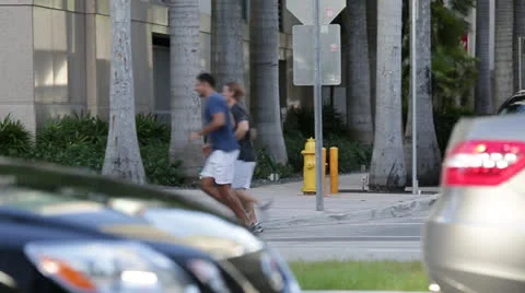 Runners Race Down Sidewalk Stock Footage 27125750