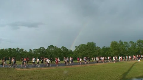 Runners in race with rainbow in background Video stock 51180504