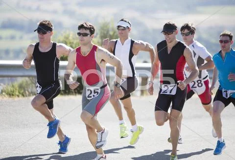 Runners in race on rural road Stock Photos