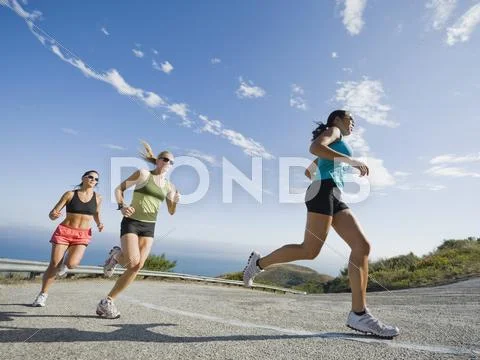 Runners on a road in Malibu Stock Photos