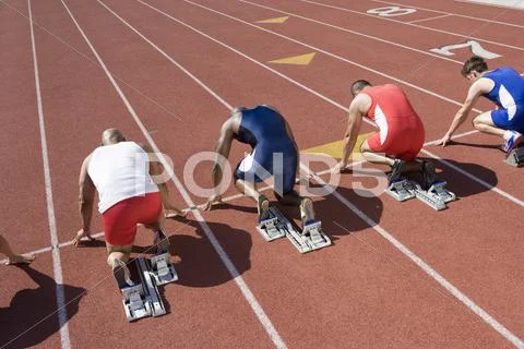 Runners At Starting Line Ready To Race Stock Photos