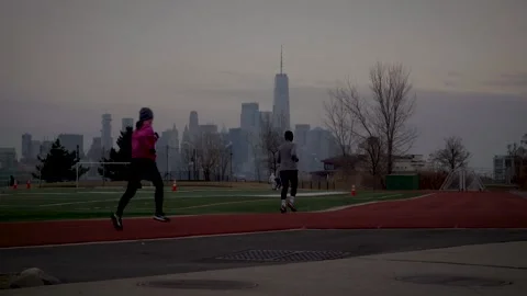 Runners On Track With NYC Skyline Stock Footage 229176975