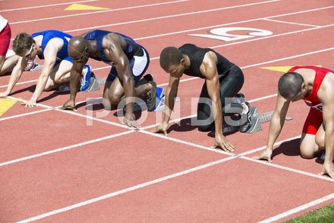 Runners Waiting At Starting Blocks Stock Photos