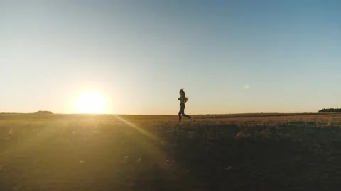 Running after sun. training jogging. A healthy beautiful girl is engaged in Stock Footage 142245365