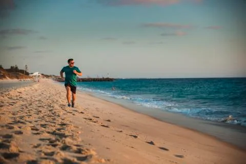 Running Along the Beach Front 库存照片